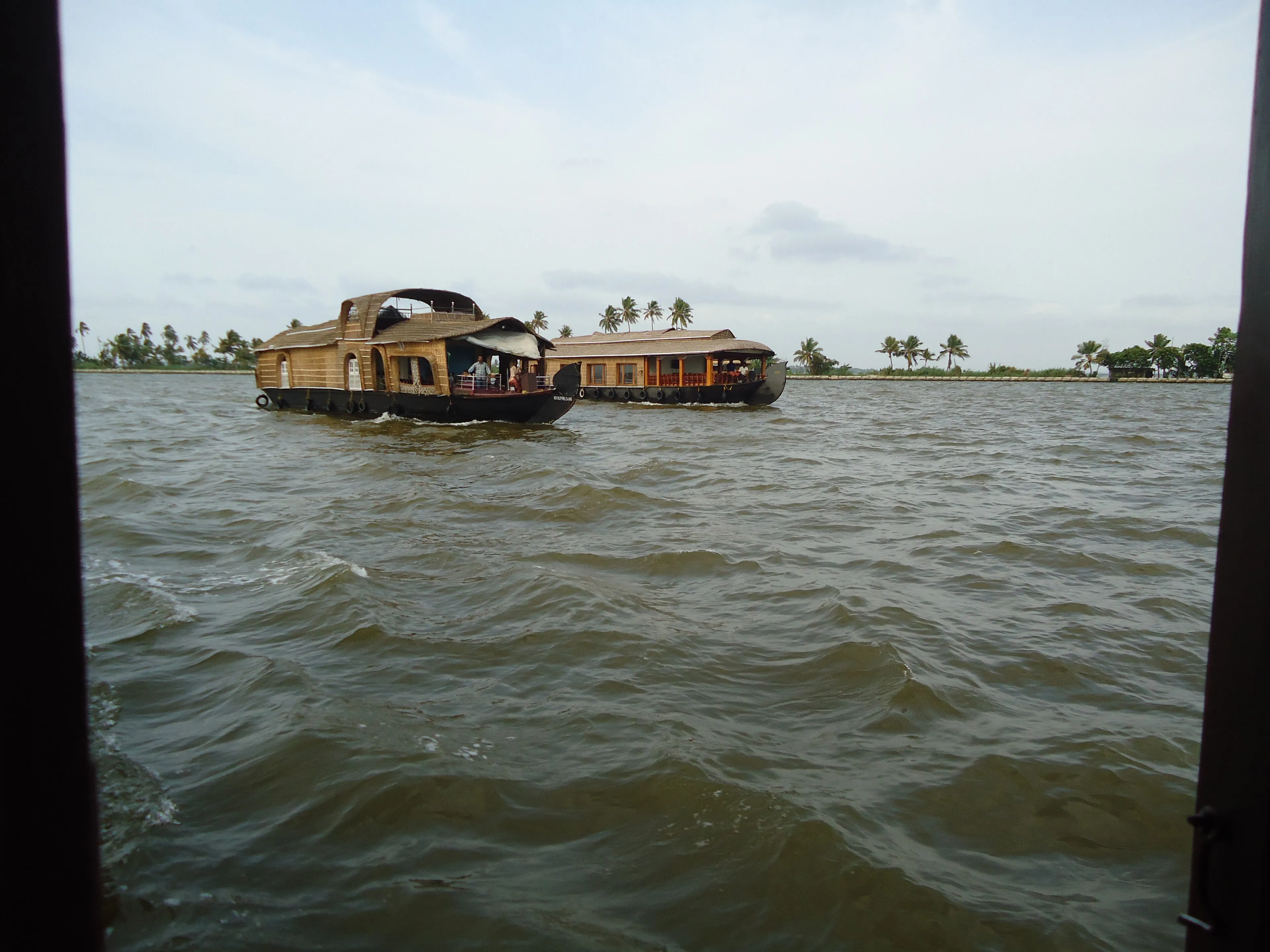 Calm morning on the Alleppey backwaters with a moored houseboat