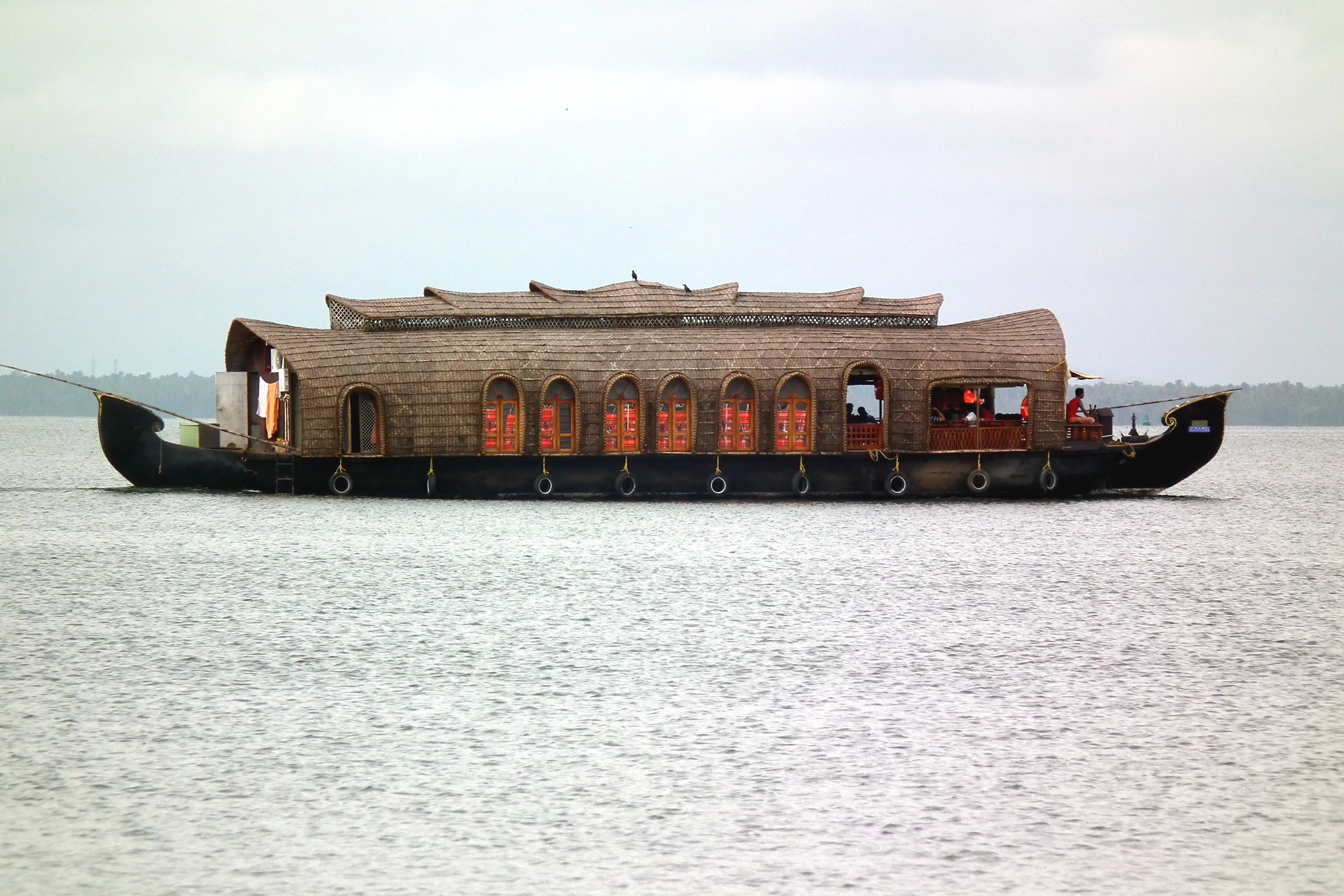 Shikara boats lined up on the calm Alleppey backwaters at dawn